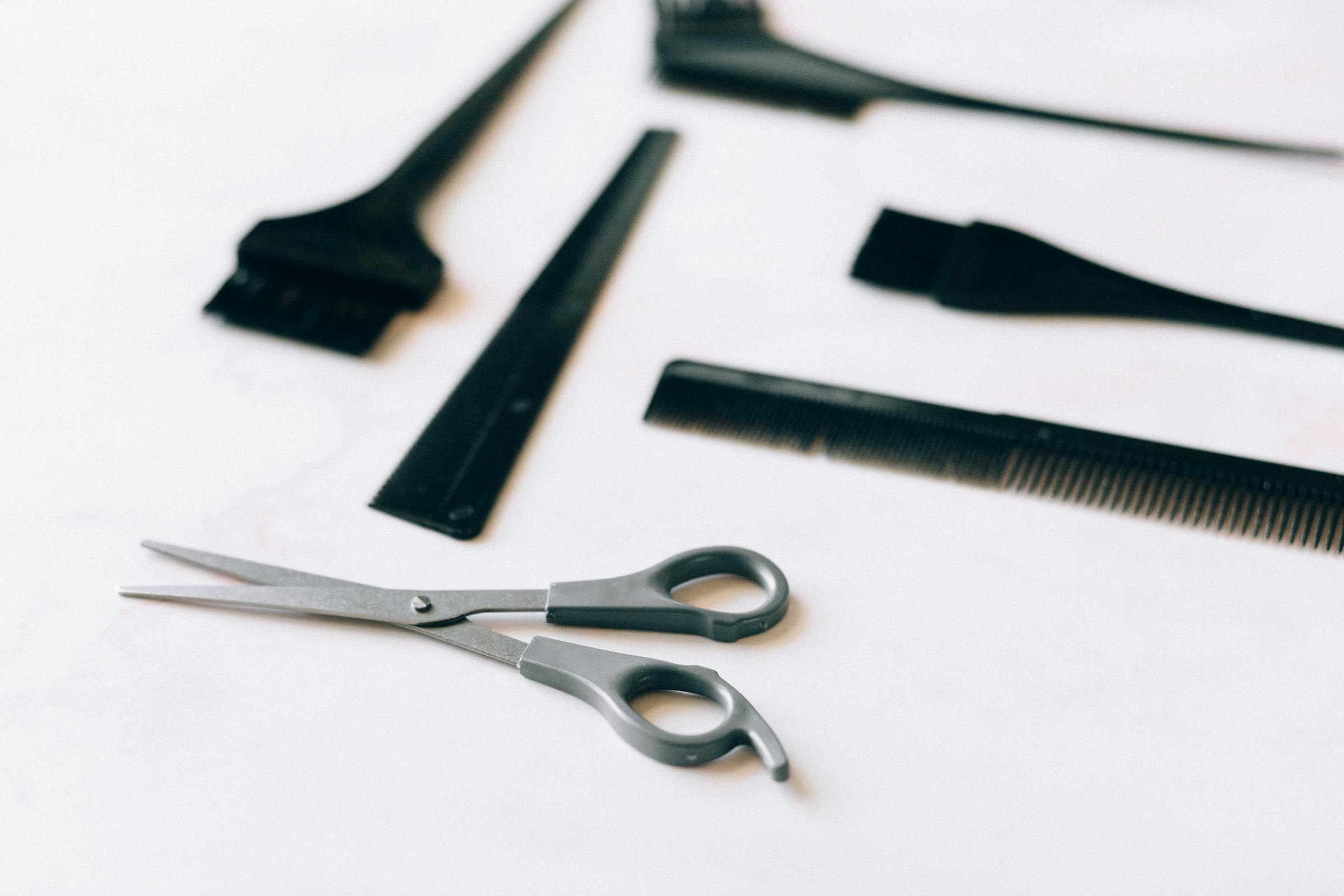 Precision cutting shears and styling tools laid out on a clean station